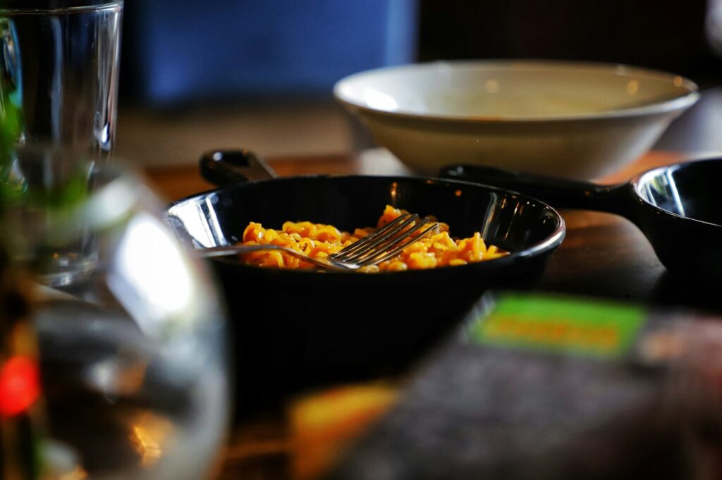 A beautifully arranged table with a bowl of food and a fork, highlighting artistic food photography.