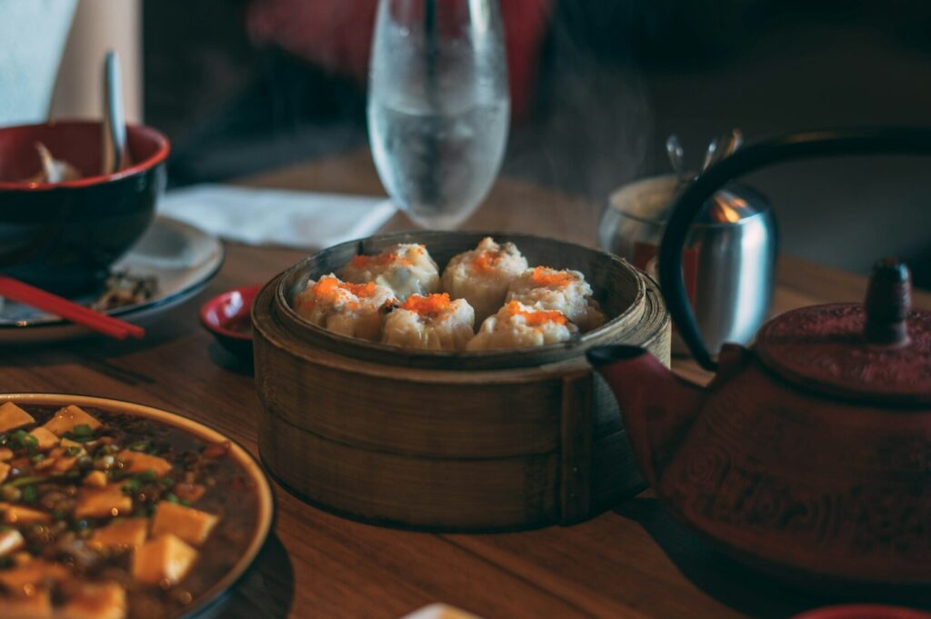 A table set with an array of delicious food and a glass of wine, highlighting Singapore's vibrant food photography scene.