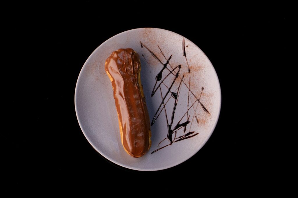 A beautifully styled plate featuring a single pastry, showcasing its texture and color.