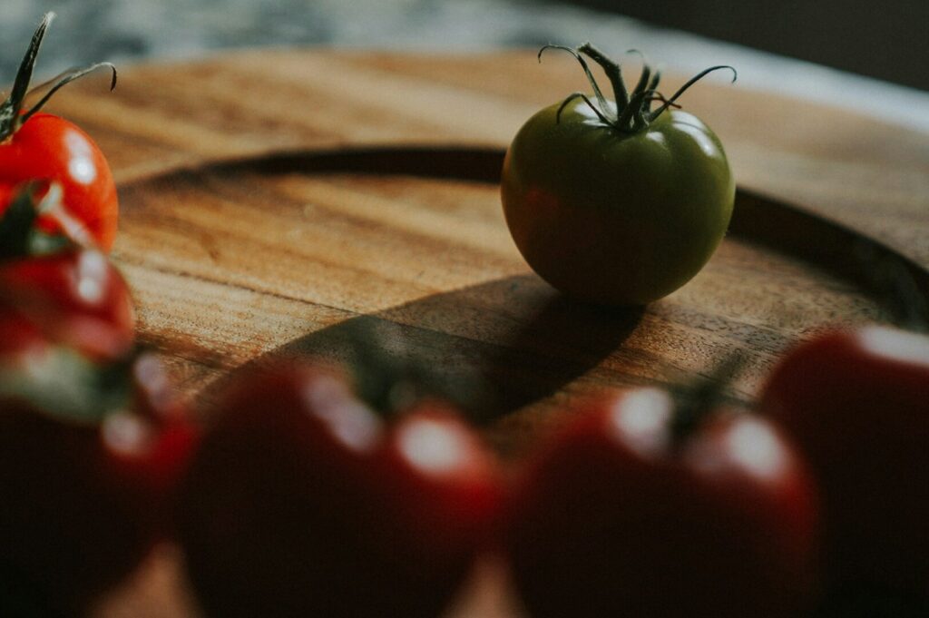 A vibrant display of tomatoes on a rustic wooden cutting board, showcasing professional food photography techniques.