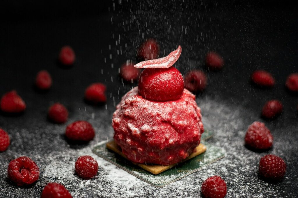 A person seated at a table, savoring a meal surrounded by an array of colorful dishes in a food photography setting.