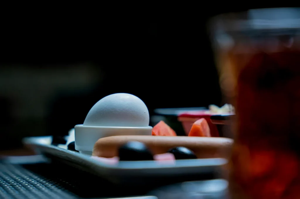Moody hotel room service breakfast tray with boiled egg.